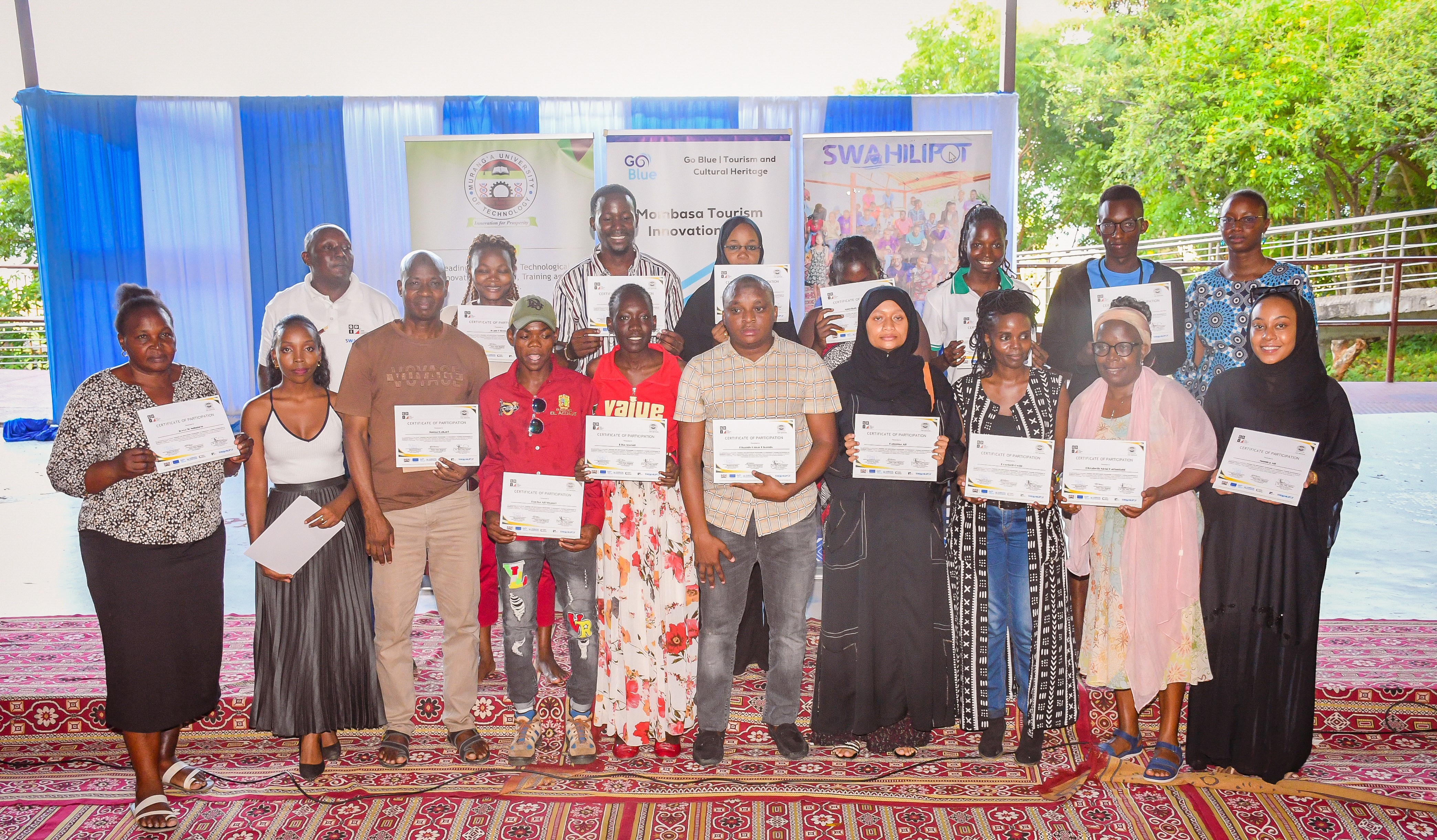 Graduands posing for a picture with their certificates